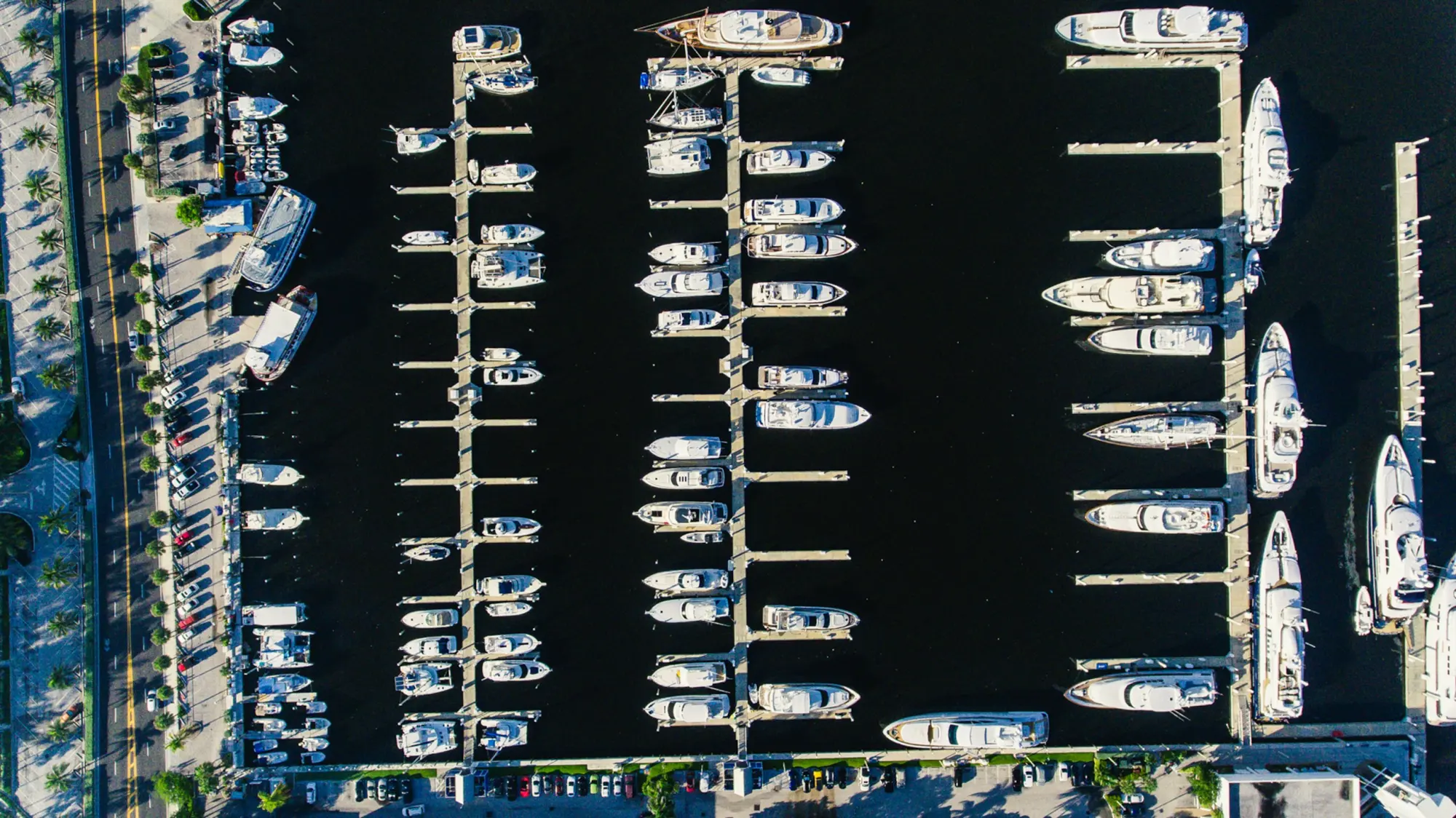 Motor yachts in their slips at a marina, seen from above